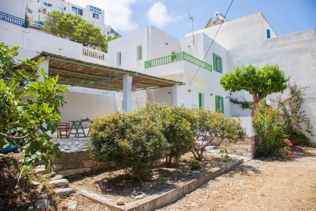 a view of a house with a patio and trees at Family Home PortoKatapola in Katapola