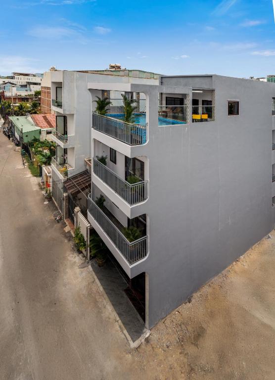 an overhead view of a white building with a swimming pool at T P Villa in Danang