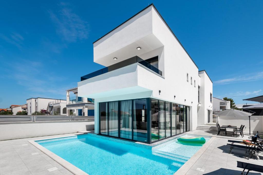a house with a swimming pool in front of it at Villa Restart Vrsi-Mulo in Vrsi