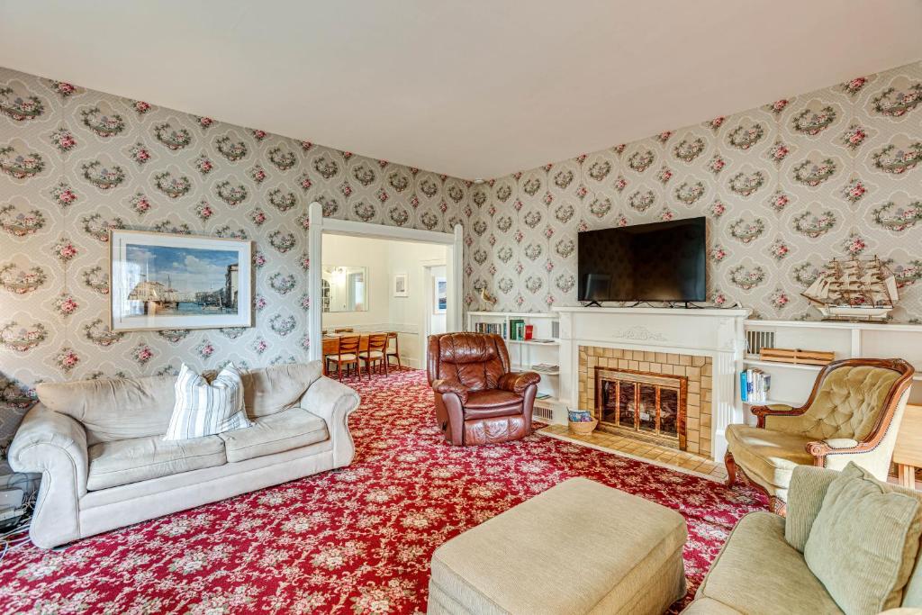 a living room with a couch and a fireplace at Walk to Lake Michigan and Dtwn Coastal Grand in Ludington