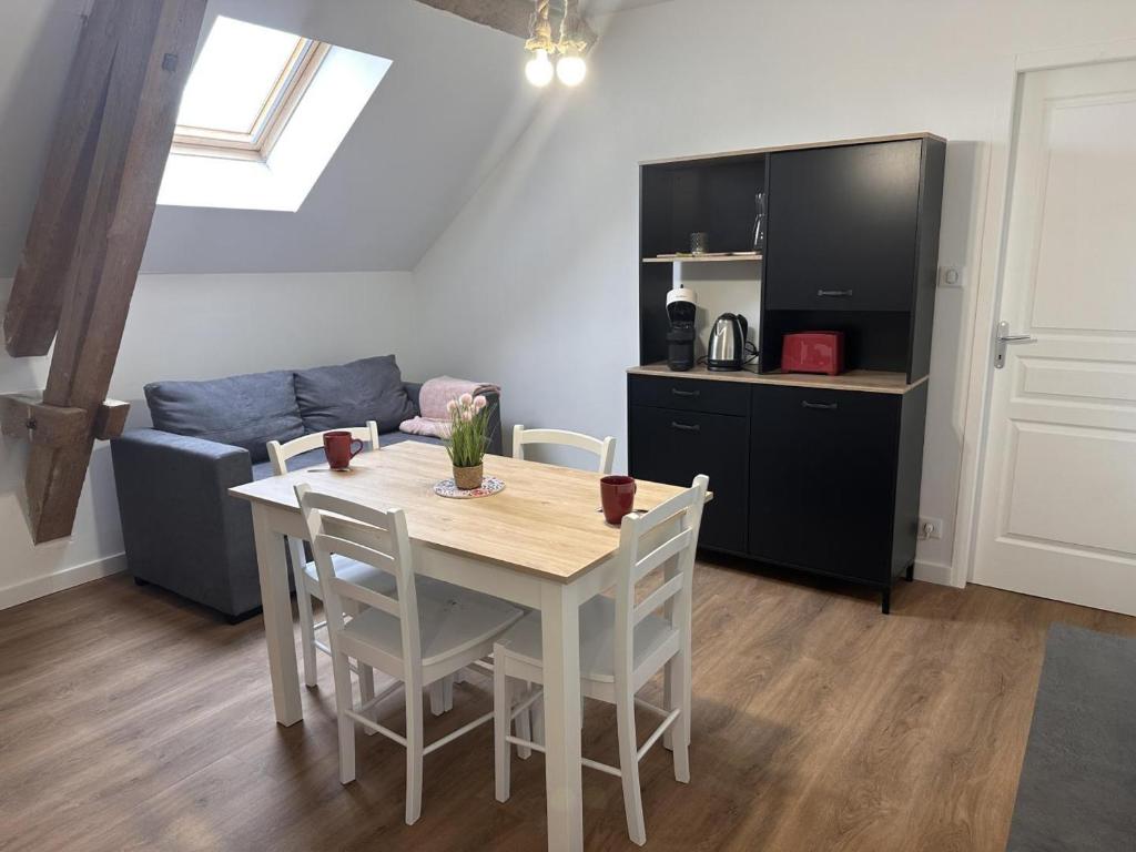 a kitchen and dining room with a table and a couch at Gîte rural avec animaux, parking et Wifi à Saint Bonnet de Four - FR-1-489-560 in Saint-Bonnet-de-Four