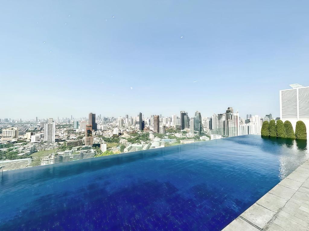 a swimming pool with a city skyline in the background at Wyndham Garden Residence Sukhumvit 42 in Bangkok