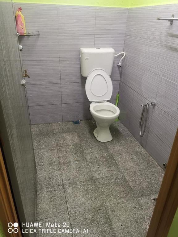 a bathroom with a toilet in a stall at LS Roomstay 2 in Kangar