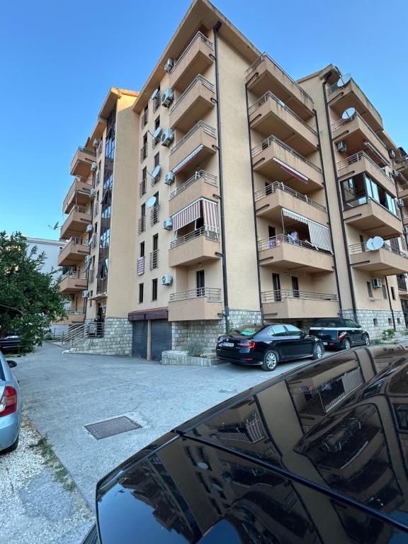 a large building with cars parked in front of it at Apartment Natasa in Budva