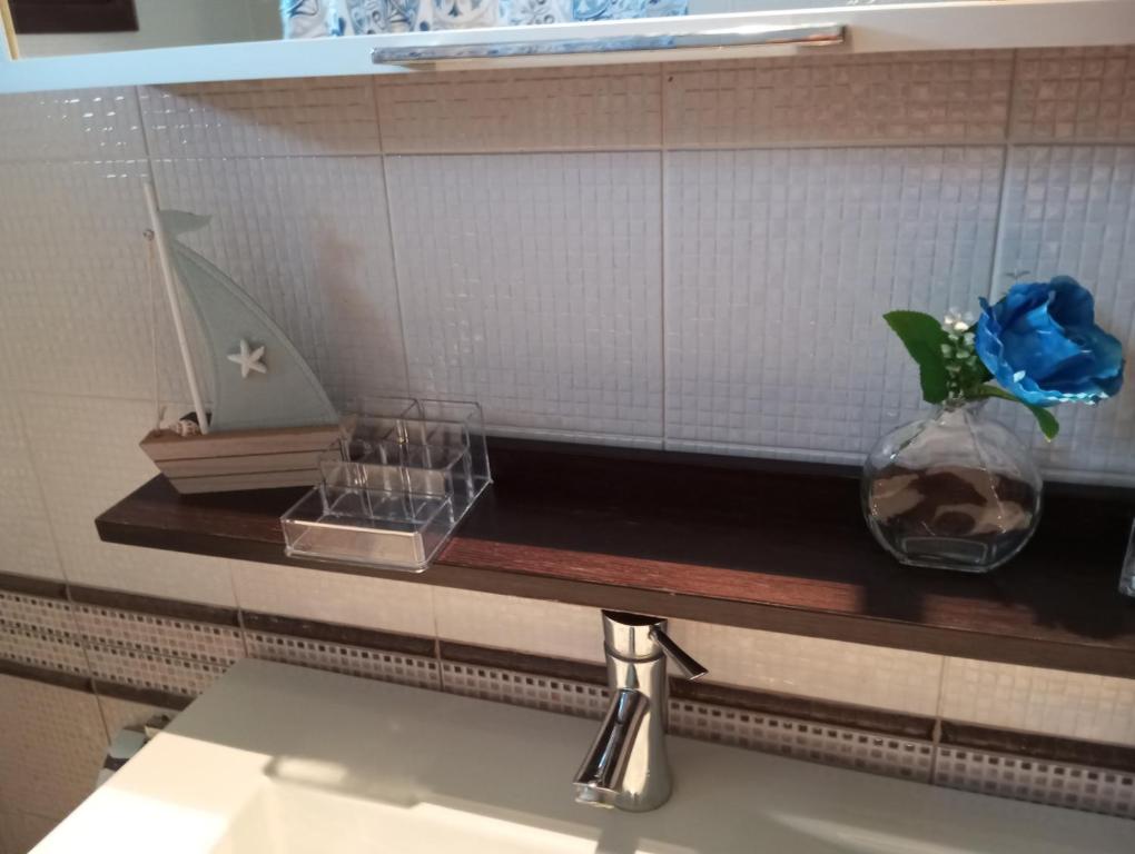 a bathroom counter with a sink and a mirror at Πολυτελης διαμέρισμα in Ierissos