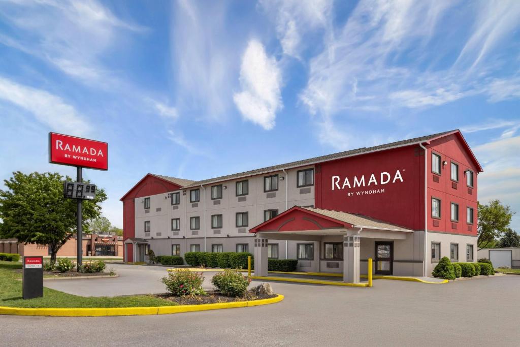 a hotel with a red and white building at Ramada by Wyndham York Harrisburg Hershey in York