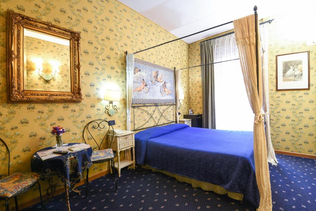 um quarto com uma cama azul e uma janela em Residenza Ave Roma em Roma