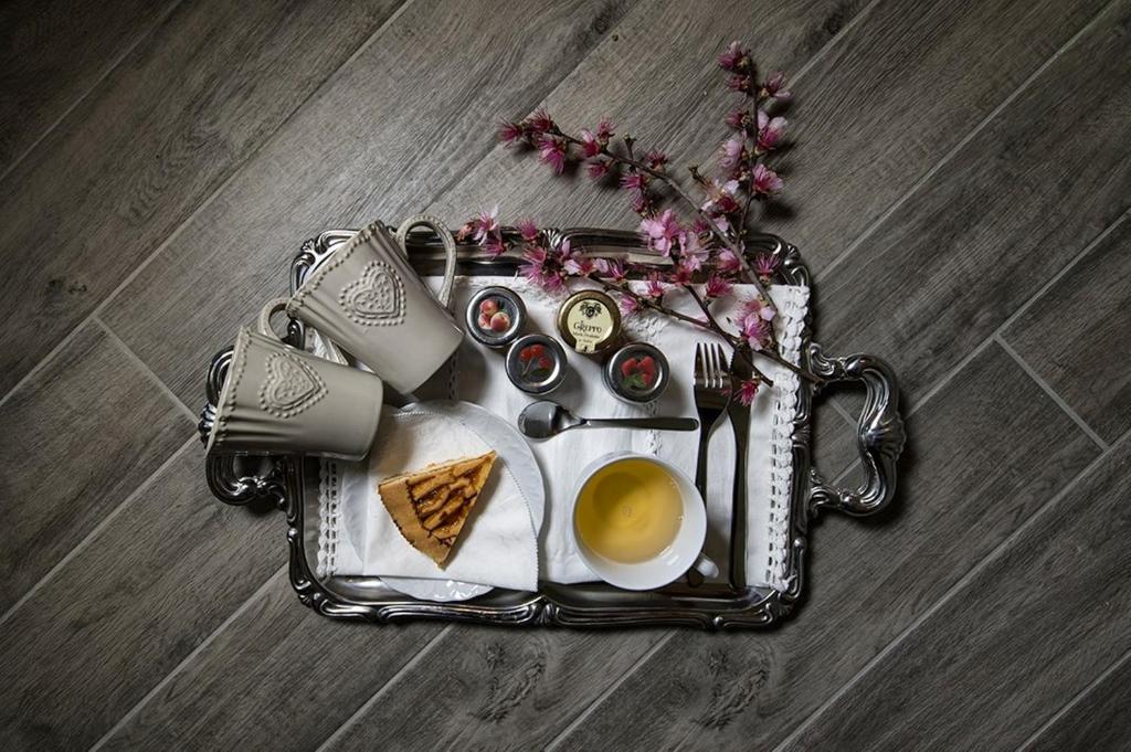 a tray with a cup of coffee and a plate of food at La Maison Sabina in Passo Corese