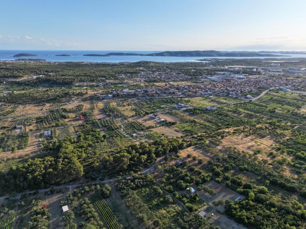 an aerial view of a city with the ocean at Vranac Country house Šibenik in Donje Polje