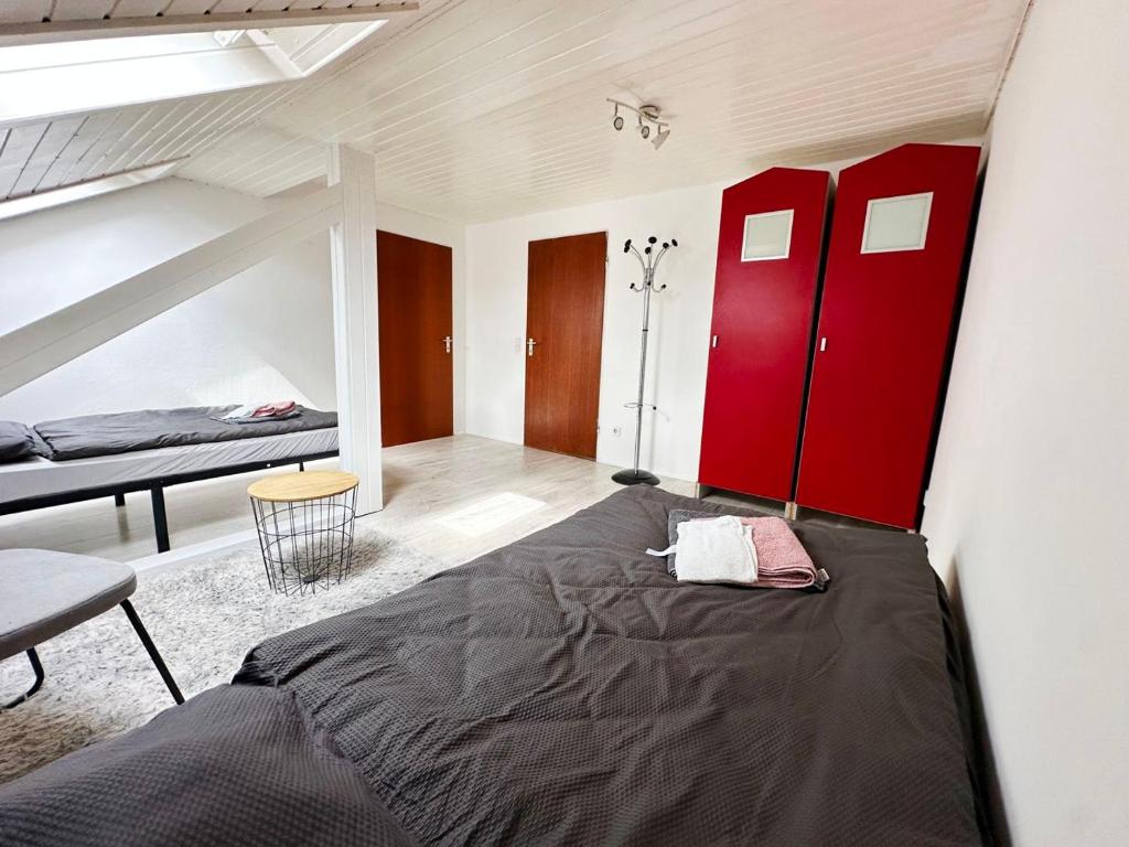 a bedroom with a large bed and red cabinets at Comfort Stay Apartment in Rüsselsheim am Main in Rüsselsheim