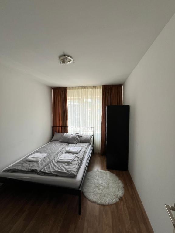 a bedroom with a bed and a white rug at COM Home Floresti in Floreşti