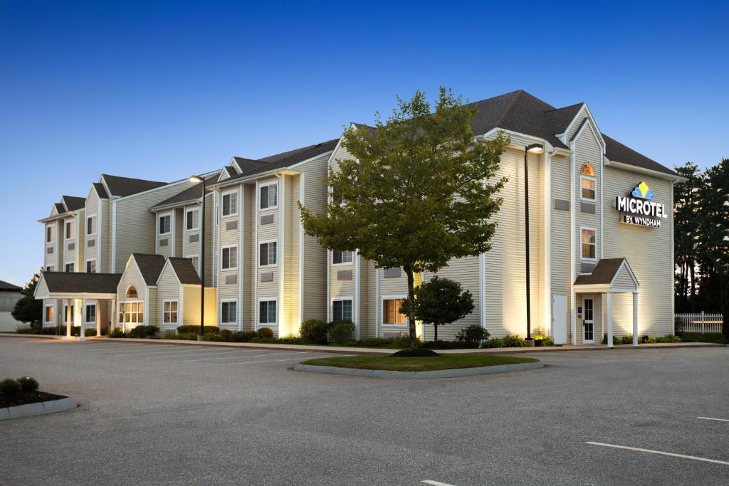 a rendering of a hotel with a parking lot at Microtel Inn & Suites Dover by Wyndham in Dover