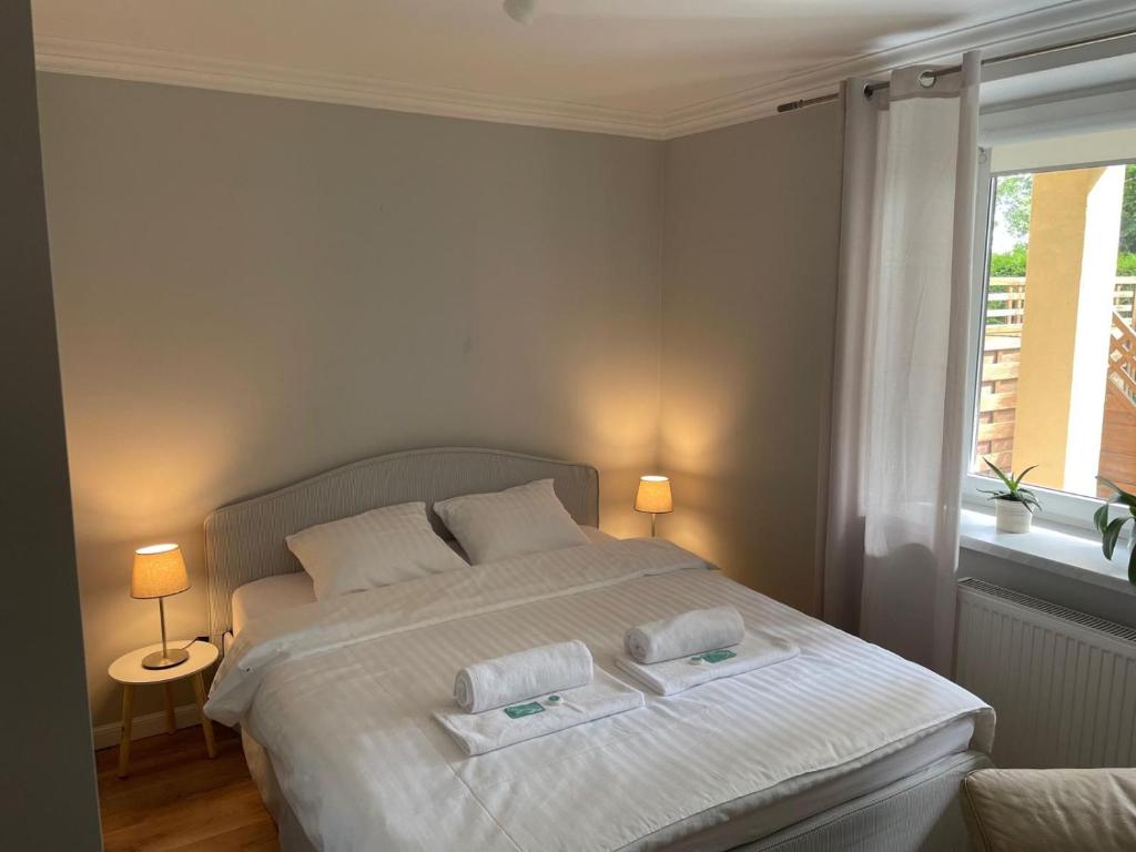 a bedroom with a bed with two towels on it at Waniliowa oaza in Puck