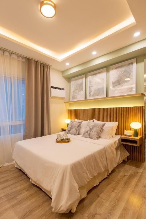 a bedroom with a large white bed in a room at La Vita by Alfredo 215 in Bacolod