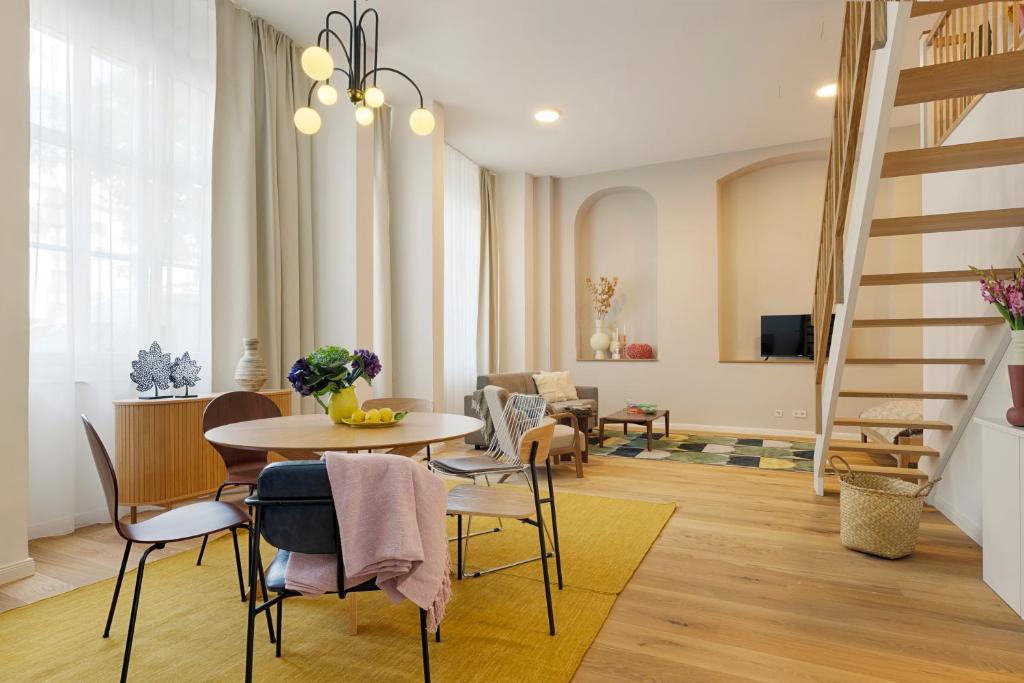 a living room with a table and chairs at homie stay Dominikus in Würzburg