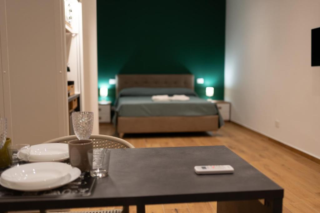 a living room with a bed and a table with a dining room at G&G Luxury Rooms in Bari