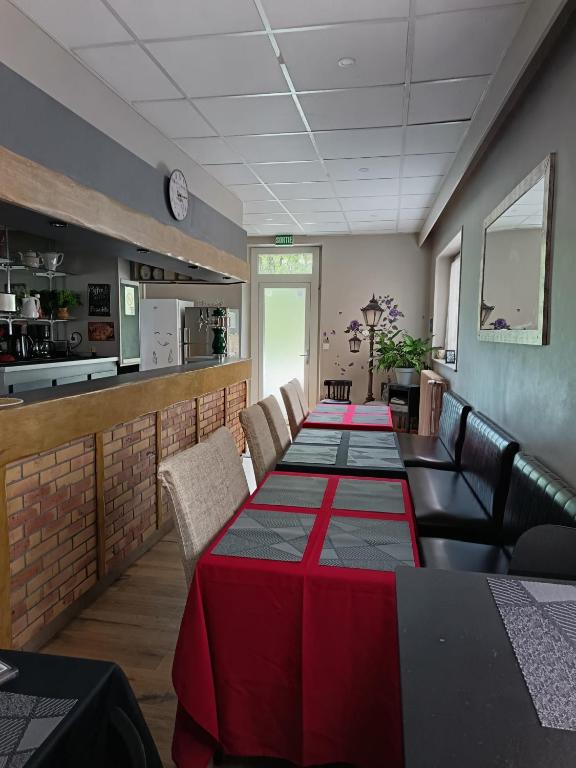 a dining room with a long table and chairs at Gite le Buron in La Bourboule
