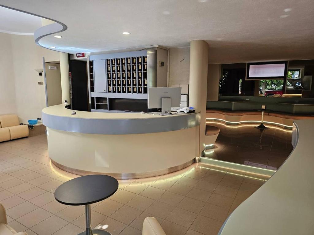 a lobby of a hotel with a bar in it at Hotel Corona in Termoli