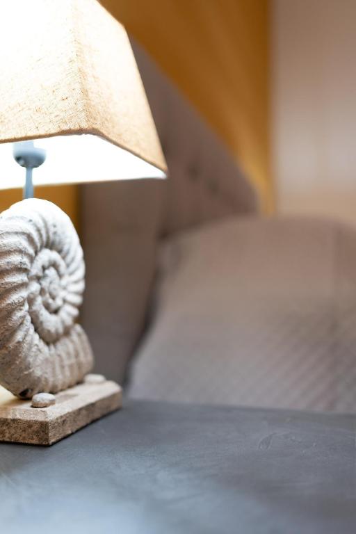 a lamp sitting on top of a bed at G&G Luxury Rooms in Bari