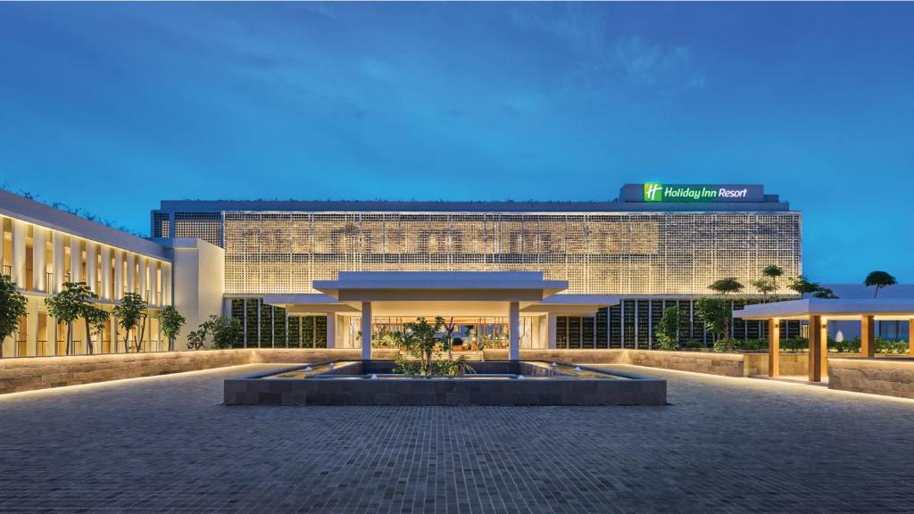 a large building with a fountain in front of it at Holiday Inn Resort Bintan Lagoi Beach by IHG in Lagoi
