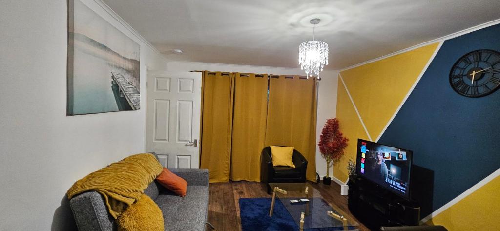 ein Wohnzimmer mit Sofa und Fernseher in der Unterkunft OG Stays III- 6bedroom house- sleeps 9persons, Near Nissan & Stadium of Light, free parking in Pallion