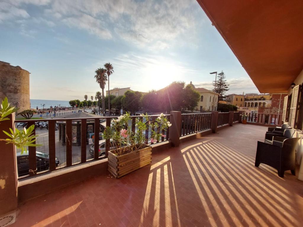 a balcony with a view of the beach and the ocean at Casa del Sole Guest House in Alghero
