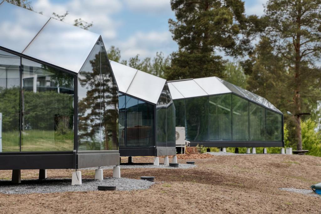 two glass houses on a field with trees at Lunar Igloos - Lumi - Ellivuori Resort in Karkku