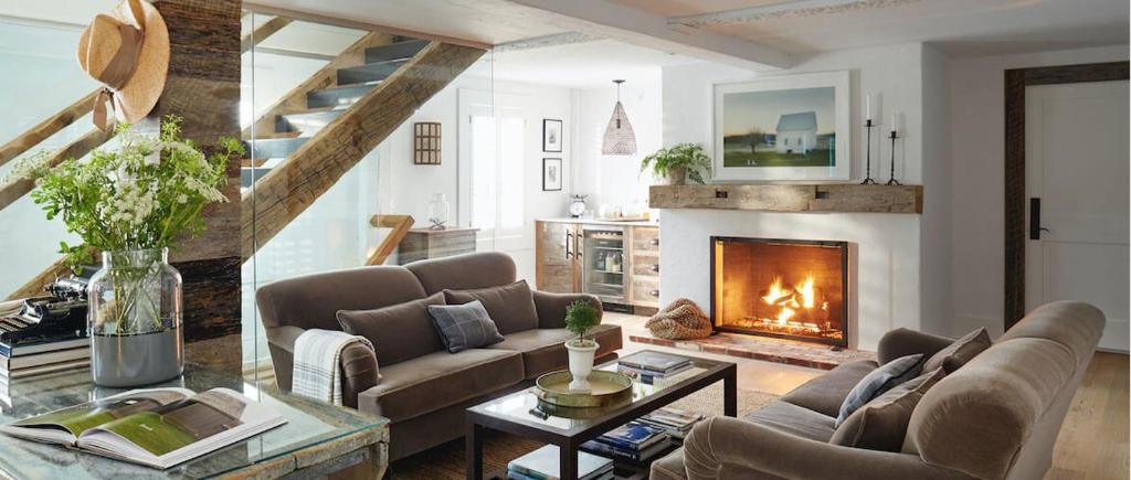 a living room with a couch and a fireplace at The Inn at GrayBarns in Norwalk