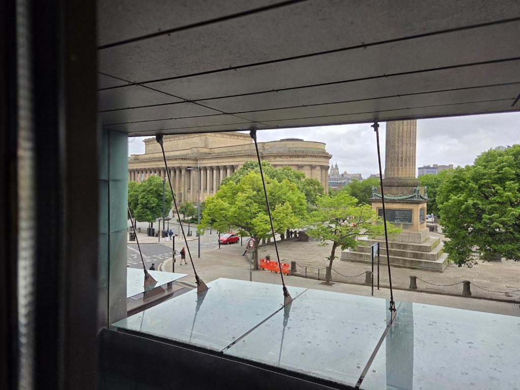 a view of a building from a window at Luxury City Center Apartment in Liverpool