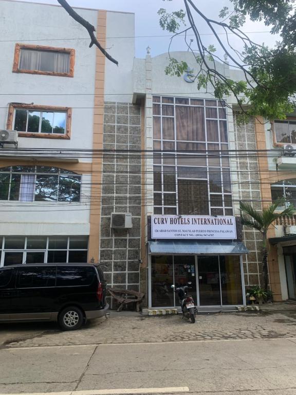 a van parked in front of a building at Curv Hotels minutes to Airport- Malls in Puerto Princesa City