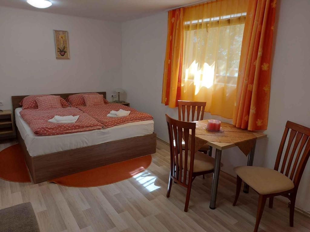 a bedroom with a bed and a table with chairs at Apartment in Balatonföldvár 18542 in Balatonföldvár