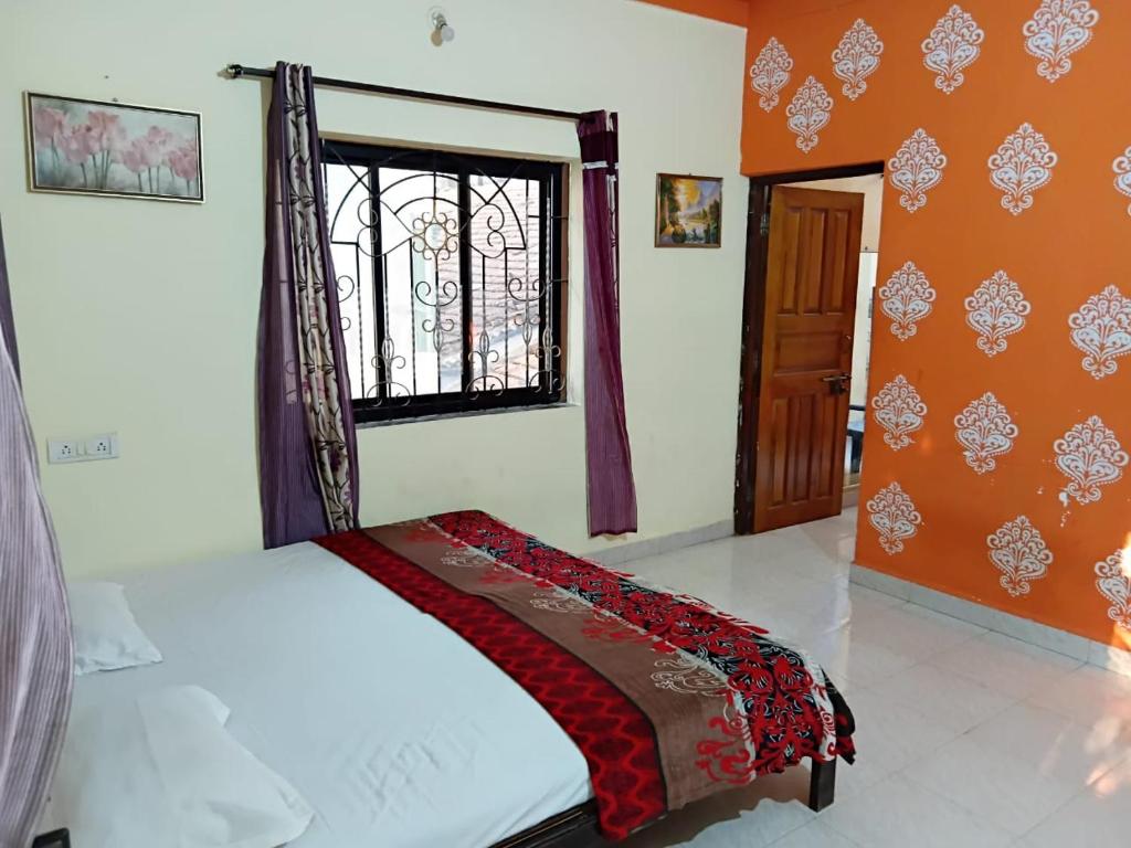 a bedroom with a bed and a window in it at Bright Beach Homestays in Calangute
