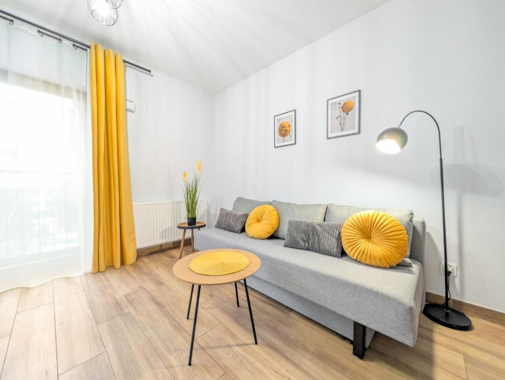 a living room with a couch and a table at Traugutta Angelcity GYM & SPA by BookingHost in Wrocław