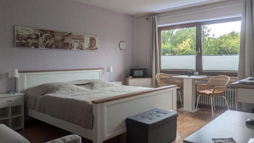 a bedroom with a bed and a desk and a window at Travemünde Kleine Perle in Lübeck