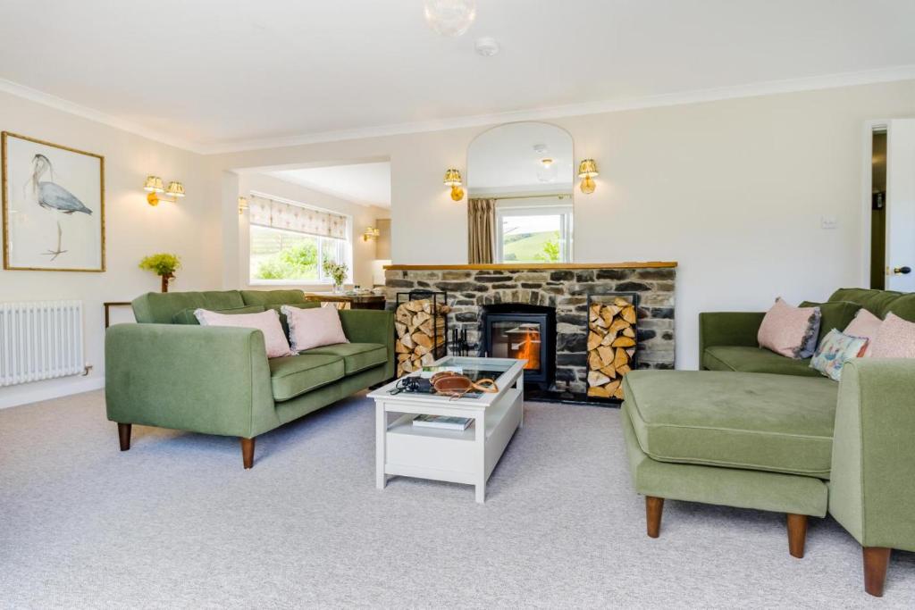 a living room with two couches and a fireplace at 3 Bed in Llanfyllin oc-i32566 in Llanfyllin