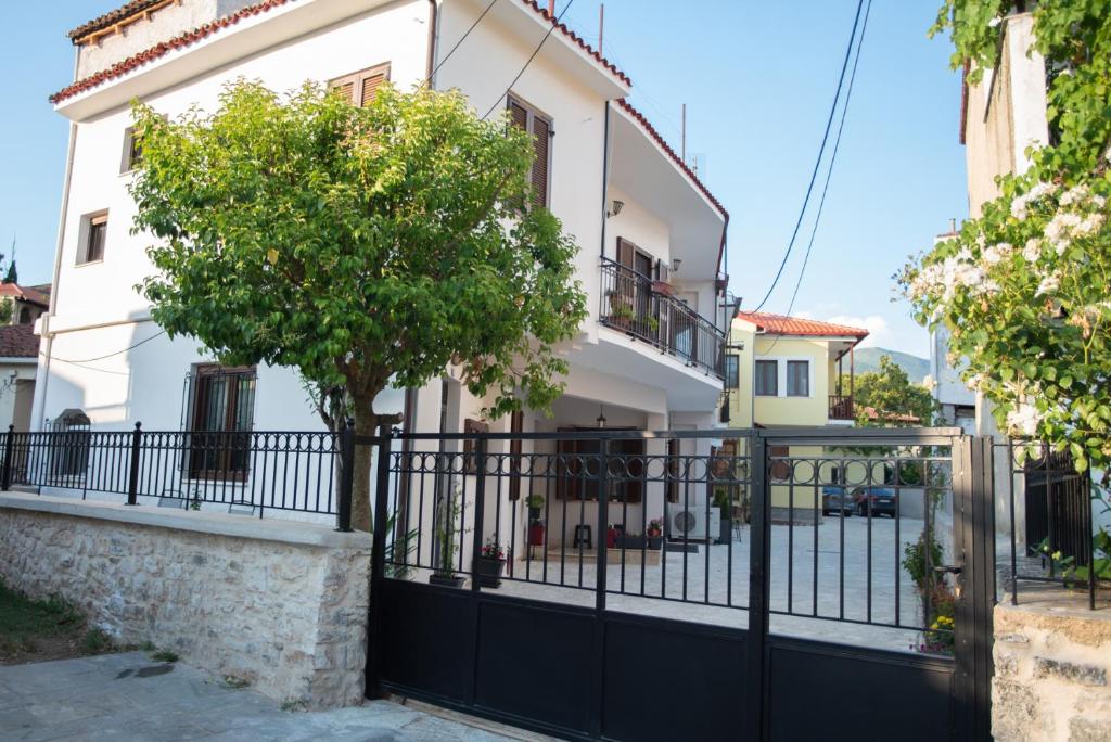 a black fence in front of a white building at Kastrino Luxury Apartment in Ioannina