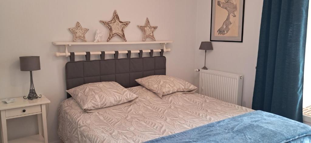 a bedroom with a bed with two pillows on it at Chez Sylvia et Patrice in Saint-Léonard