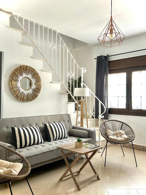 a living room with a couch and a staircase at CENTER APARTMENT Mazagón in Mazagón