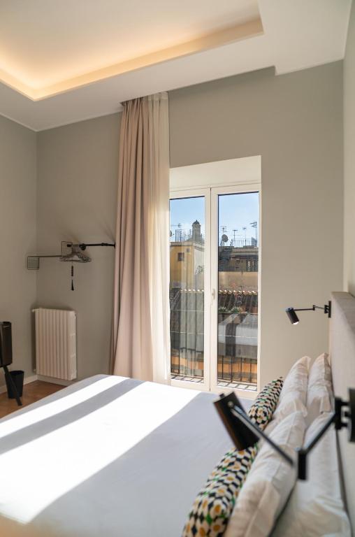 a bedroom with a bed and a large window at Deluxe Spaccanapoli in Naples