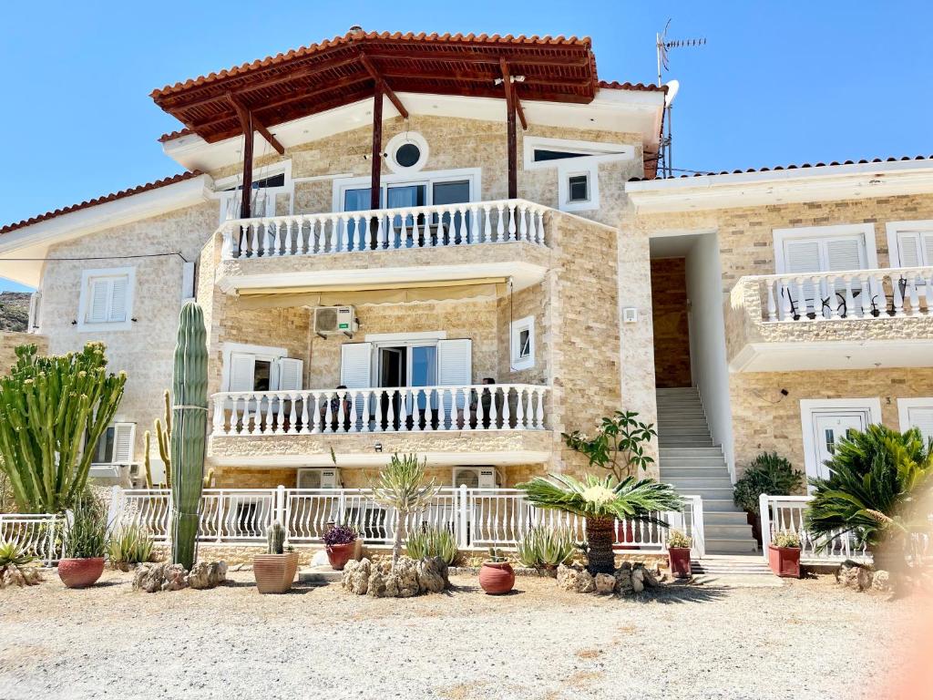 a large house with cacti in front of it at Nomads in the south in Tsoutsouros