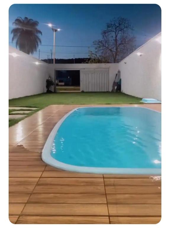 a large blue swimming pool on a wooden floor at aconchego da Lenna in Juazeiro do Norte