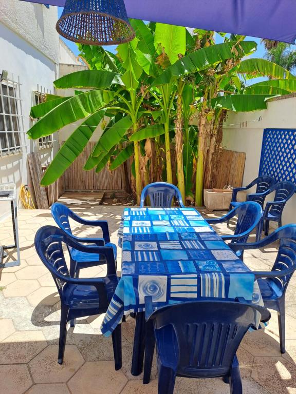 a table and chairs with a blue and white at Donna Cecilia in Santa Maria al Bagno