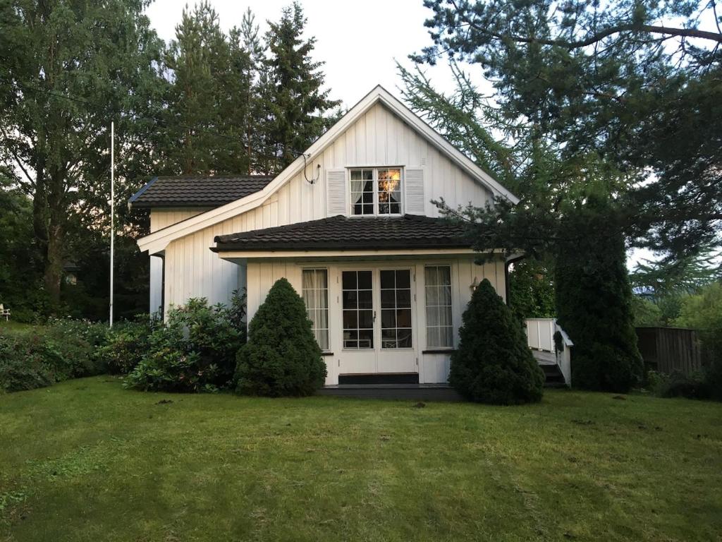 a white house with a window and a yard at Welcome to Dalborg, only 1,5 hours from Oslo 