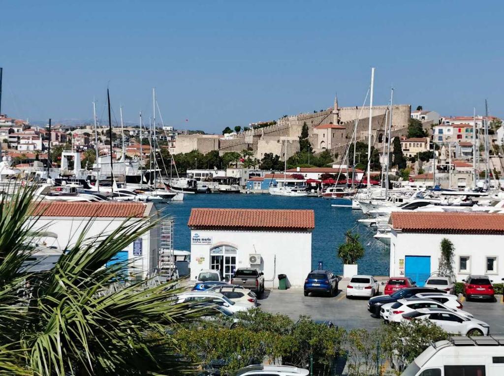 a marina with cars parked in a parking lot at Marina Guest House in Çeşme