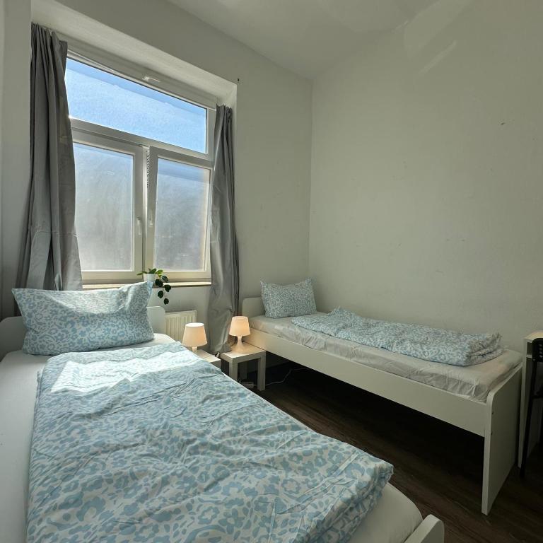 a bedroom with two beds and a window at WDI - WorkersSpace in Bochum