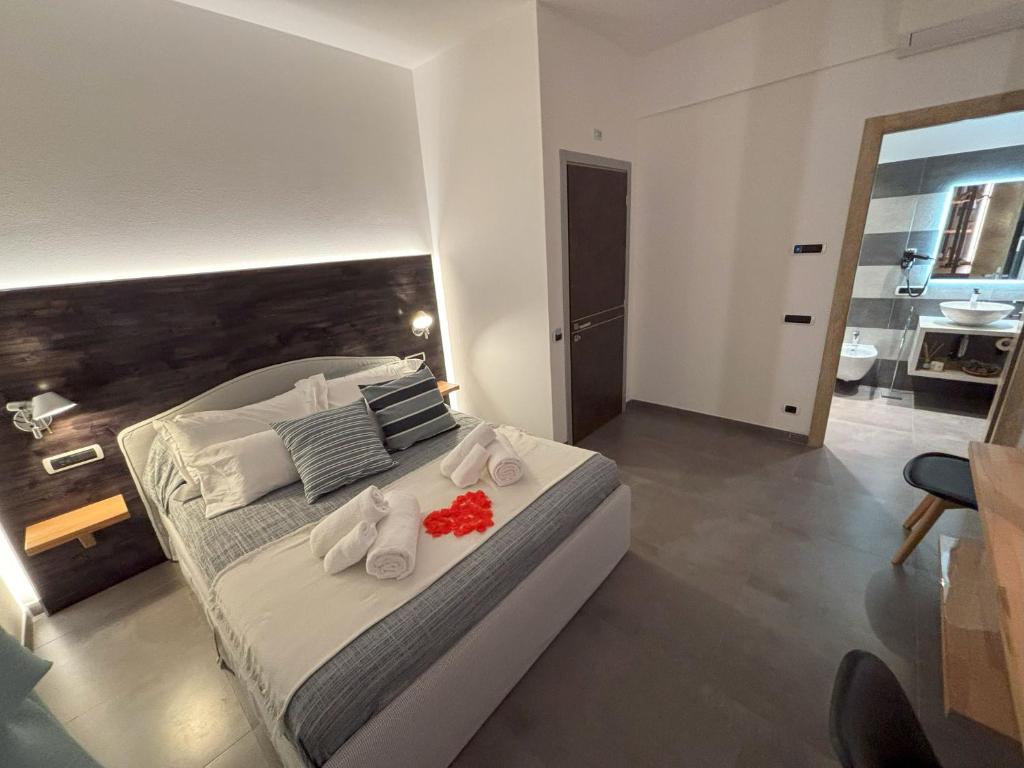 a bedroom with a large bed with towels on it at Metropolitan in La Spezia
