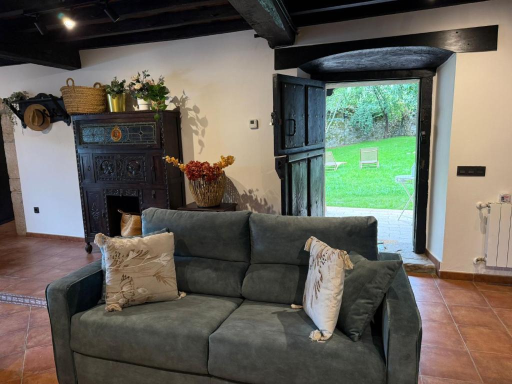 a living room with a couch and a large window at La Quintana de Los Valles in Benia