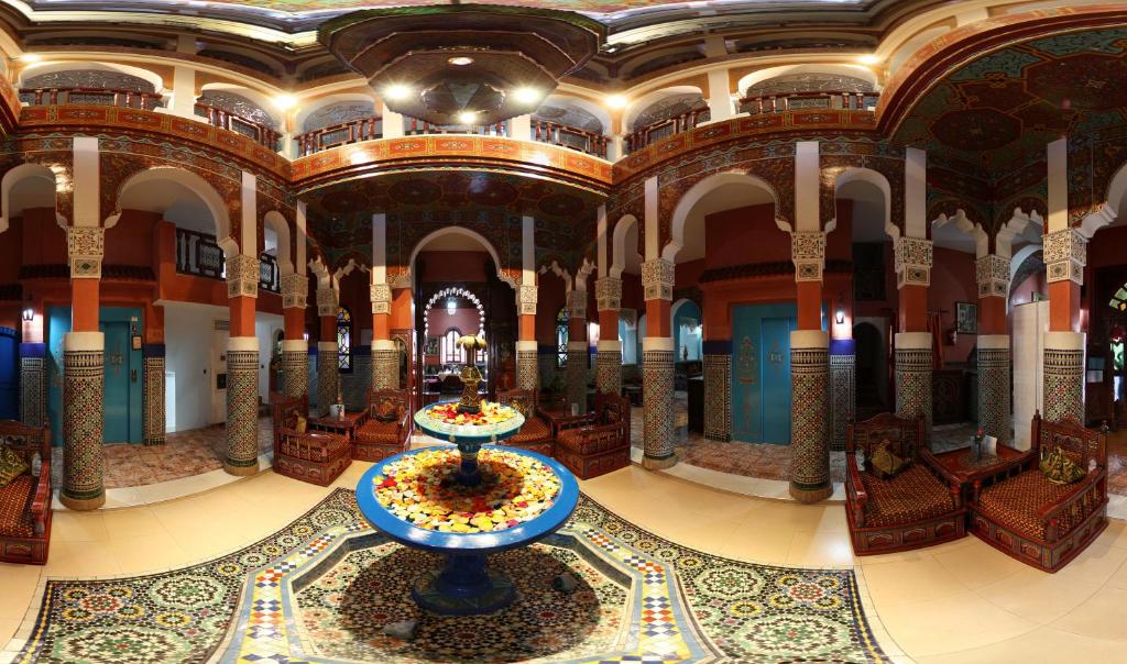 Moroccan House في مراكش: غرفة كبيرة مع نافورة في وسط المبنى