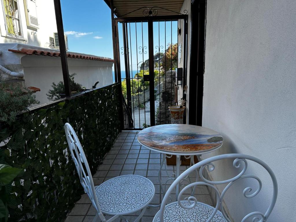 a patio with a table and chairs on a balcony at Lost In Amalfi in Amalfi