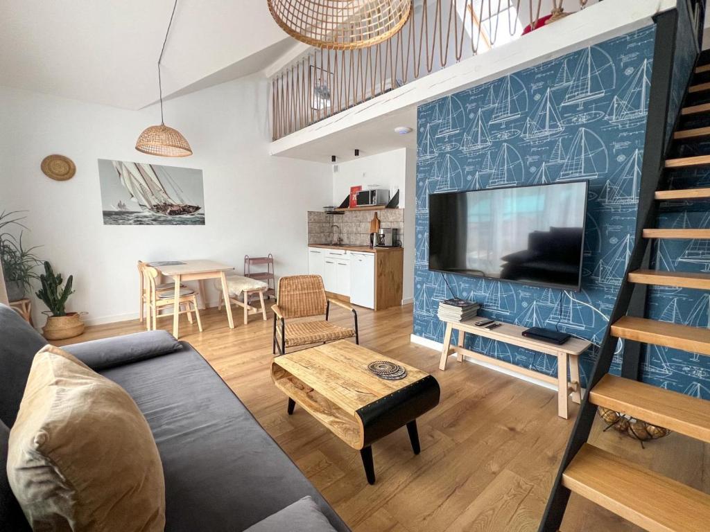 a living room with a couch and a tv at Mado in Władysławowo